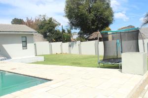 a backyard with a pool and a fence at Home Away From Home in Johannesburg