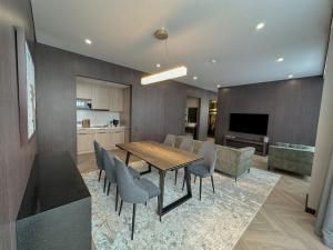 a kitchen and dining room with a table and chairs at Resident City Hotel in Almaty
