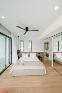 a bedroom with a bed and a ceiling fan at Elia Cove Luxury Villa with private Pool in Loutraki