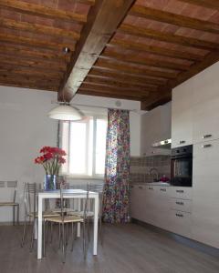 a kitchen with a table and chairs in a kitchen at Tana Dell'Orso in Ponsacco