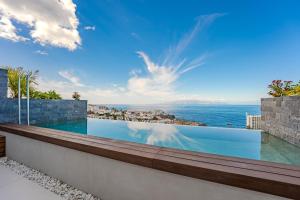 a swimming pool with a view of the ocean at Luxury triplex + pool, jacuzzi - SissiPark Azul in Acantilado de los Gigantes