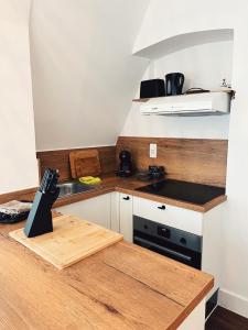 a kitchen with a wooden counter top and a sink at Studio Bella in De Panne +8 photos