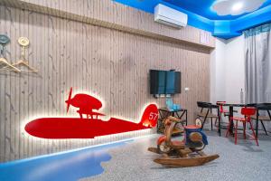 a room with a red surfboard on the wall at 精彩奇寓站前電梯主題民宿走路到車站好停車 in Hualien City