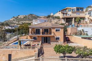 a large house with a staircase leading up to it at Villa Dos Perlas in Alicante