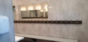a bathroom with two mirrors on the wall at Umfors Camping in Umasjö