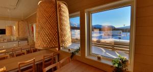 a dining room with a window and a table and chairs at Umfors Camping in Umasjö