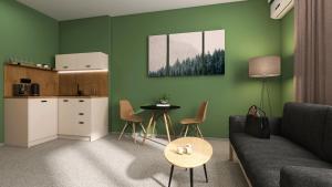a living room with a couch and a table and a kitchen at Hotel Etropol, Center Etropole in Etropole