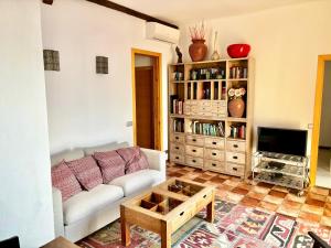 a living room with a couch and a tv at Barceloneta Ramblas Apartments in Barcelona
