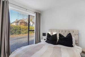 a bedroom with a bed and a large window at Little Laxford in Fazeley