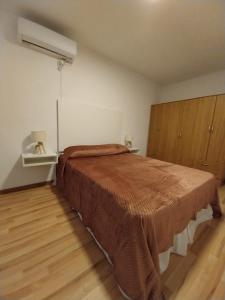 a bedroom with a large bed and wooden cabinets at Moras Morada in Almafuerte