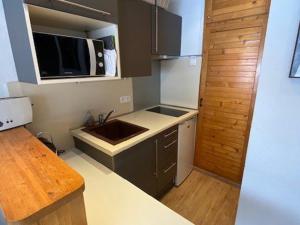 a small kitchen with a sink and a microwave at Studio Arette, 1 pièce, 4 personnes - FR-1-602-115 in Arette