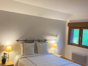a bedroom with a bed with two lamps and a window at Guestroom Basse-sur-le-Rupt, 1 pièce, 2 personnes - FR-1-589-624 in Basse-sur-le-Rupt