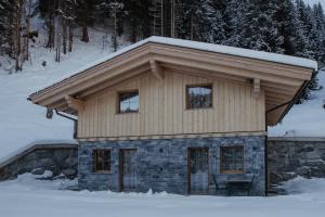 a small house with snow on top of it at Bergler Hoamat 5 - 8 Personen in Navis