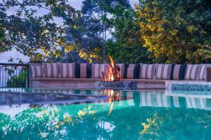 a fire pit next to a pool with a couch at Kandy Dendrobium House in Kandy