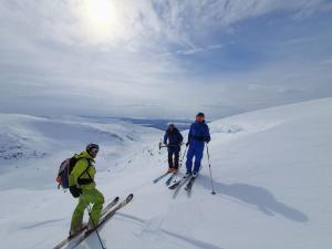 three people on skis on a snow covered slope at Umfors Camping in Umasjö +33 photos