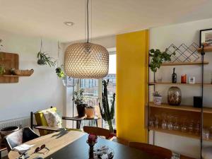 a dining room with a table and a pendant light at Penthouse: Copenhagen delight in Copenhagen