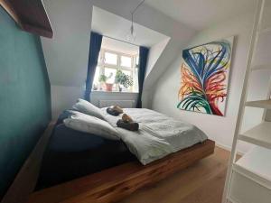 a bedroom with a teddy bear laying on a bed at Penthouse: Copenhagen delight in Copenhagen