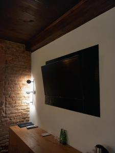 a flat screen tv hanging on a wall at Hotel Rubinstein in Kraków