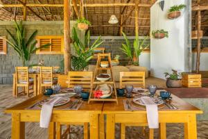 a dining room with a wooden table and chairs at Komba Cabana in Nosy Komba