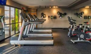 a gym with several treadmills and exercise bikes at Itaim Bibi - The Capital Flat - Apto 1211 in Sao Paulo