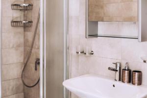a bathroom with a sink and a shower at Royal Townhouse in Center Paphos in Paphos City