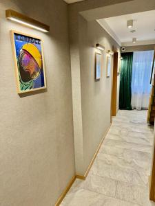 a hallway with a painting of a basketball player on the wall at Richmount Apartamenty Karpacz in Karpacz