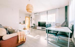 a living room with a couch and a table at Nice Home In Valldemar With Wifi in Gornal