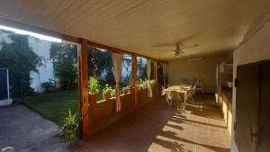 a house with a patio with a table and windows at CASA AMPLIA Y CONFORTABLE in Cordoba