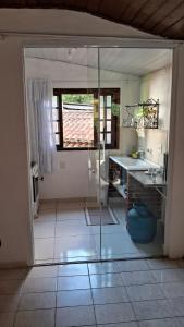 a bathroom with a glass shower and a sink at Chalé do riacho 1 in Itatiaia