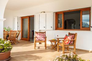 a living room with chairs and a table at New! Villa Can Pere Blai in Santa Eularia des Riu