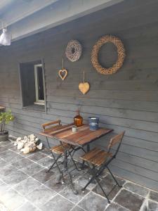 a wooden table with chairs and hearts on a wall at Gite de la Chapelle option SPA in Verchocq +31 photos