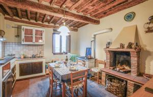 a kitchen and dining room with a table and a fireplace at 2 Bedroom Pet Friendly Home In Borgo A Mozzano in Borgo a Mozzano
