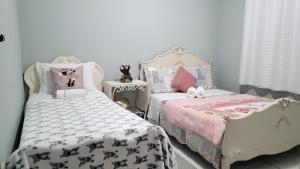 Un pat sau paturi într-o cameră la Casa Rosa Lumiar, Cachoeira Particular e Fazendinha