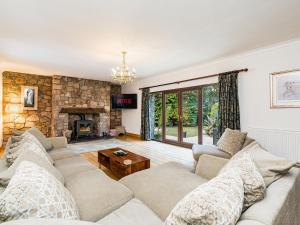 a living room with a couch and a fireplace at Brookway Lodge in Holywell