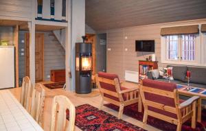 a living room with a table and chairs and a kitchen at Lovely Home In Geilo With Wifi in Geilo