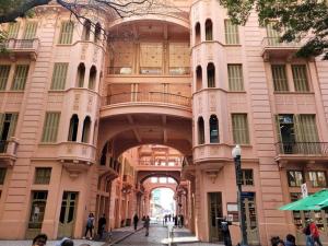 a large building with an archway in a city at De frente para o Guaíba. in Porto Alegre