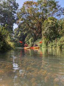 - un groupe de personnes faisant du canoë-kayak sur une rivière dans l'établissement Nature Spot Cottages, à Kurchi