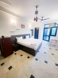 a bedroom with a bed and a ceiling fan at Hauz Khas Villa 2 in New Delhi