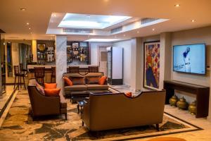 a living room with two couches and a bar at Golden Tulip Lekki in Lekki