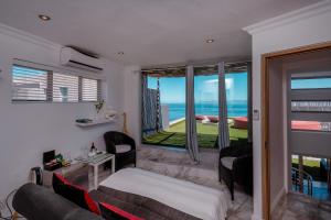 a living room with a view of the ocean at Sea Star Lodge in Gansbaai +52 photos
