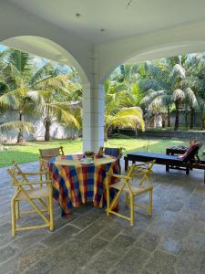 a patio with a table and two chairs and a table and a table and chairs at Villa La more in Unawatuna