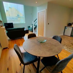 a living room with a table and chairs at Maple Gardens Studio in Church Fenton