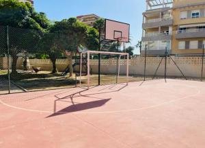a basketball hoop on a court in front of a building at Apartamento 1ª LINEA PLAYA MUCHAVISTA in El Campello