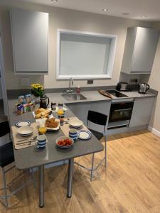 a kitchen with a table with food on it at Lovely flat, balcony & woodstove, parking close in St. Agnes