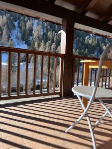 a white chair sitting on a porch with a view at Heart of Cogolo with Terrace in Cogolo