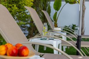 a bowl of fruit sitting on a table with chairs at Accomoteleia Blue Villa in Protaras
