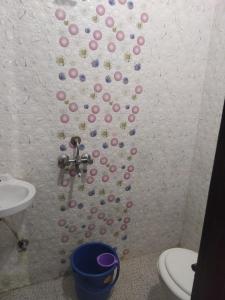 a bathroom with a wall with pink and purple buttons at Hotel sambhodhi palace in Bhopal
