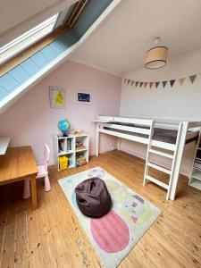 Zimmer mit einem Etagenbett und einem Schreibtisch in der Unterkunft Spacieuse maison - Petite mer in Riantec