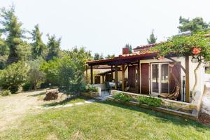 a small house with a garden in front of it at Sani Bliss by halu!, 2-BD villa with private garden in Sani Beach