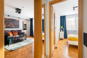 a living room with a couch and a bed at Kairos Apartments - Spodek II - 100 m od Spodka in Katowice +25 photos